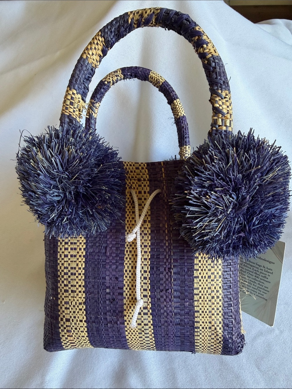 Shebobo New with tag blue and tan stripe  mini bag with pompoms.  Straw.